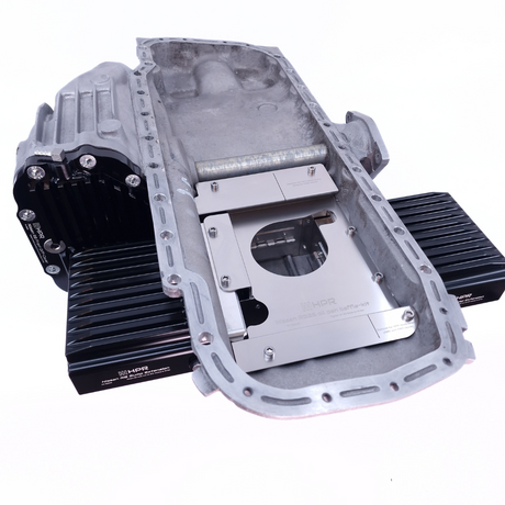 A RB26 sump extension kit, consisting of billet sump extensions and a reinforced front diff cover, appears metallic and silver in color.